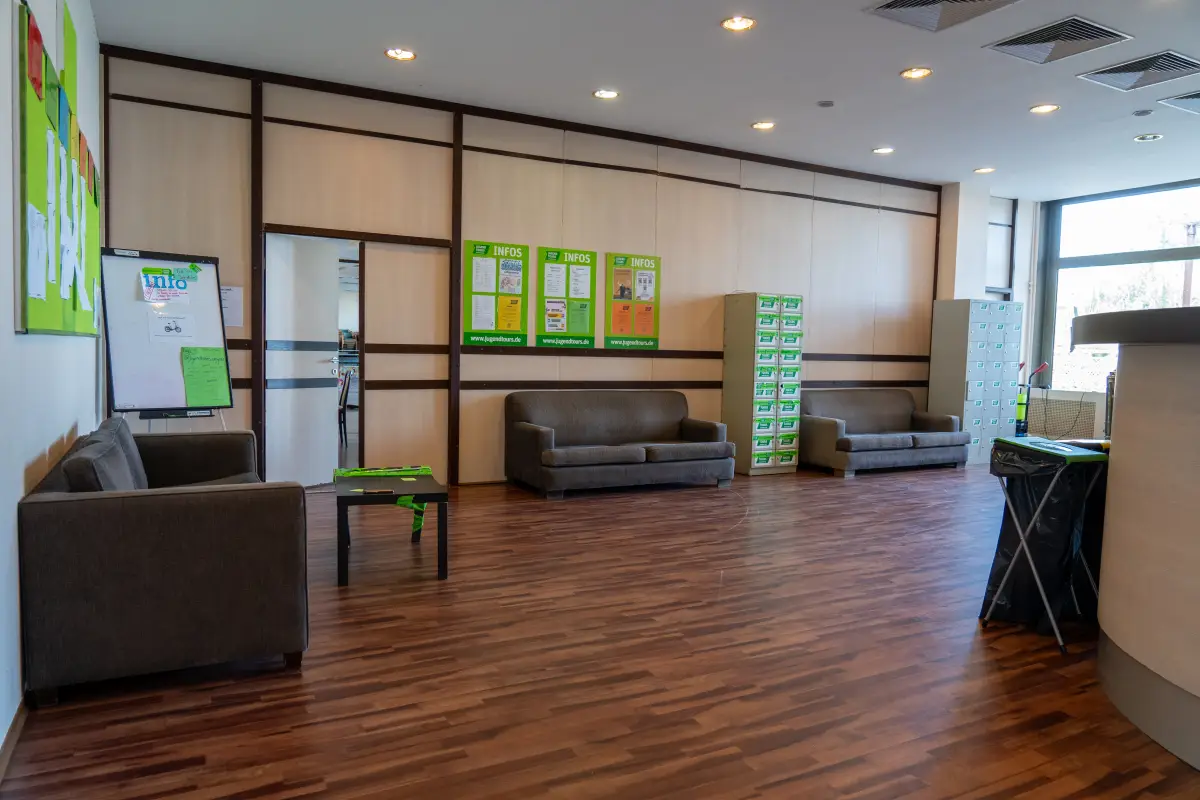 A club room with sofas, a flipchart and noticeboards along the wall