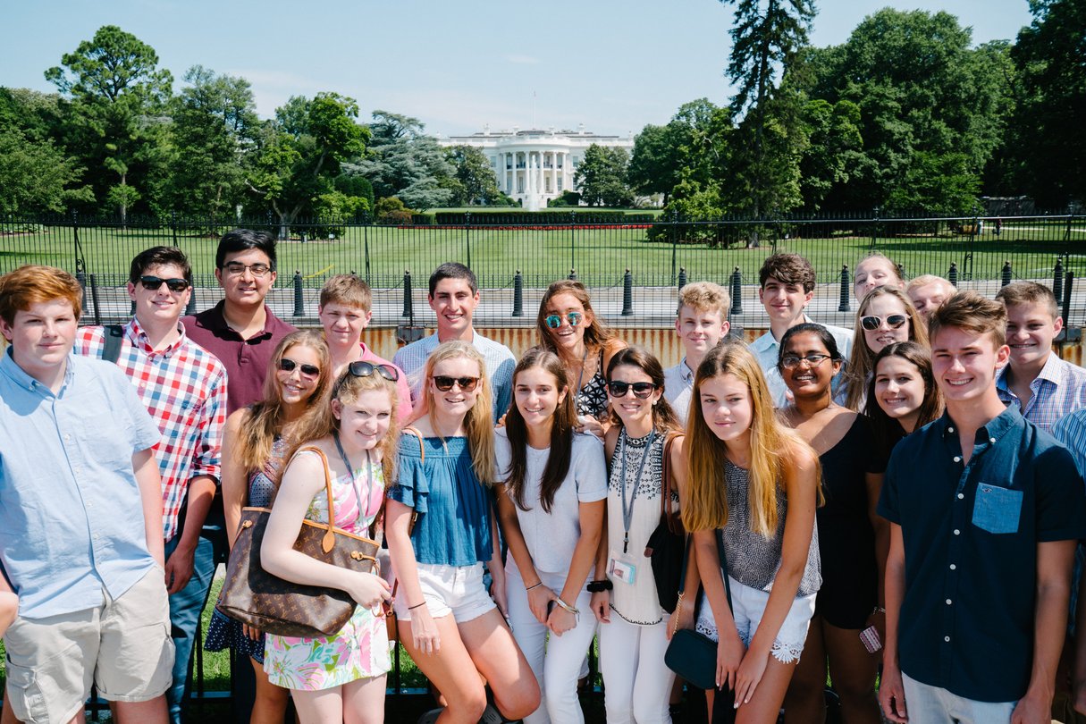 Group of high school students posing together in front of the White House in Washington, D.C.