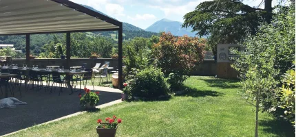 The covered terrace looking out over the garden and the Drome hills