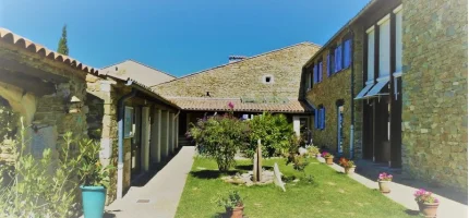 The inner courtyard of the Domaine, with stone walls and blue shutters