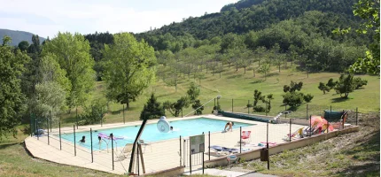 The outdoor swimming pool of the centre, open in summer, with the hills behind