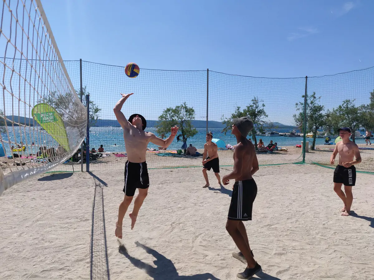 Beach volleyball match on the sand beside the Adriatic at Biograd