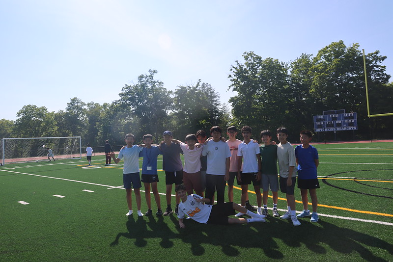 Students gathered on the turf playing field during afternoon activity time