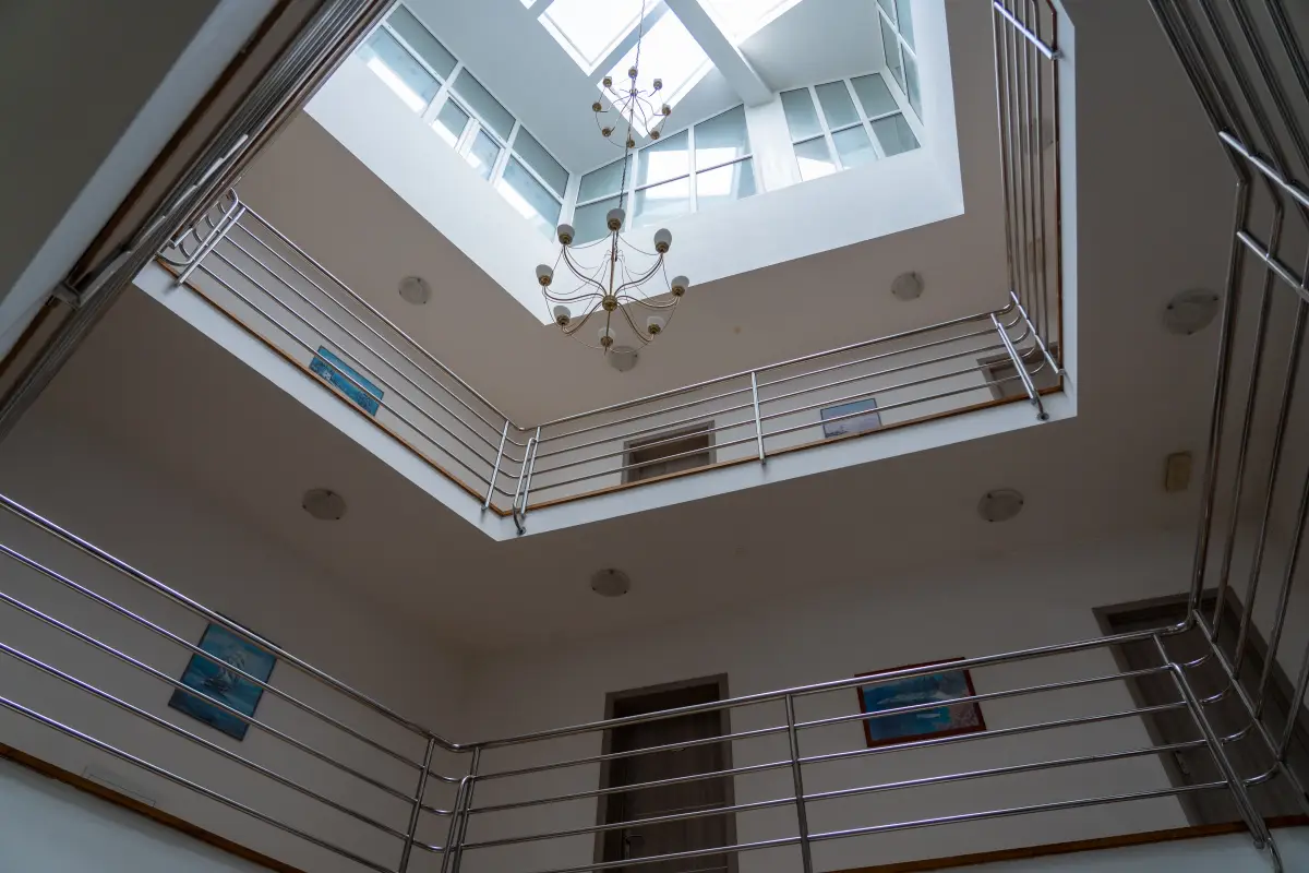 Bright interior atrium and stairwell of Hotel Marin, daylight falling from a glass roof