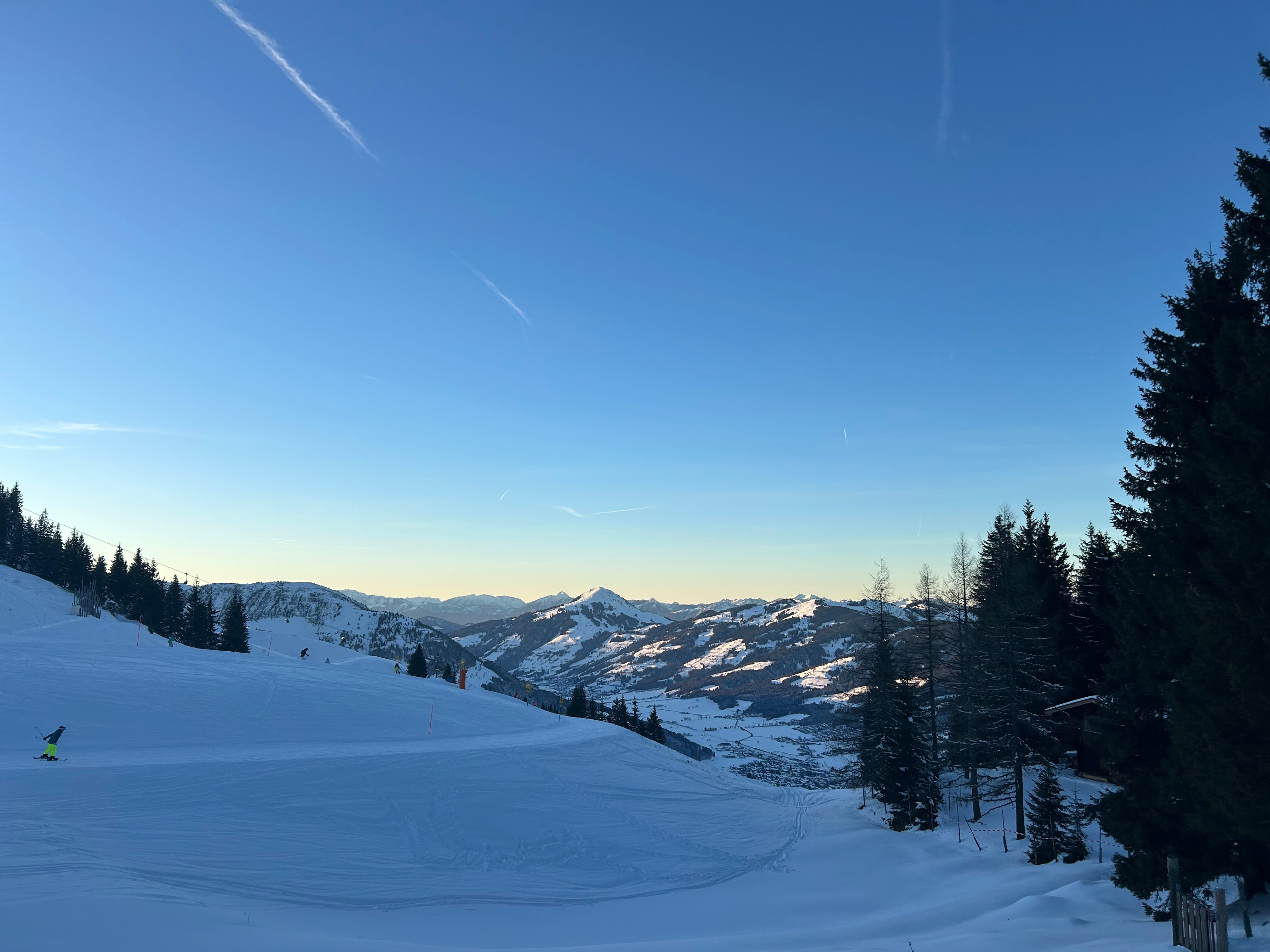 A ski piste with the mountains behind, in the Kitzbuehel area