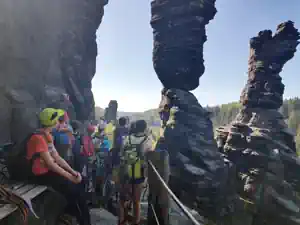 Group of children with helmets at the Herkules pillar rock towers in the Bielatal