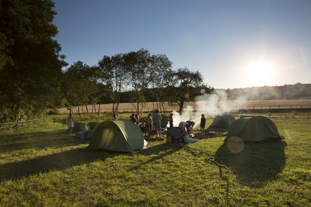 Tents set up in a meadow at sunset for the overnight bivouac out with the ponies and horses