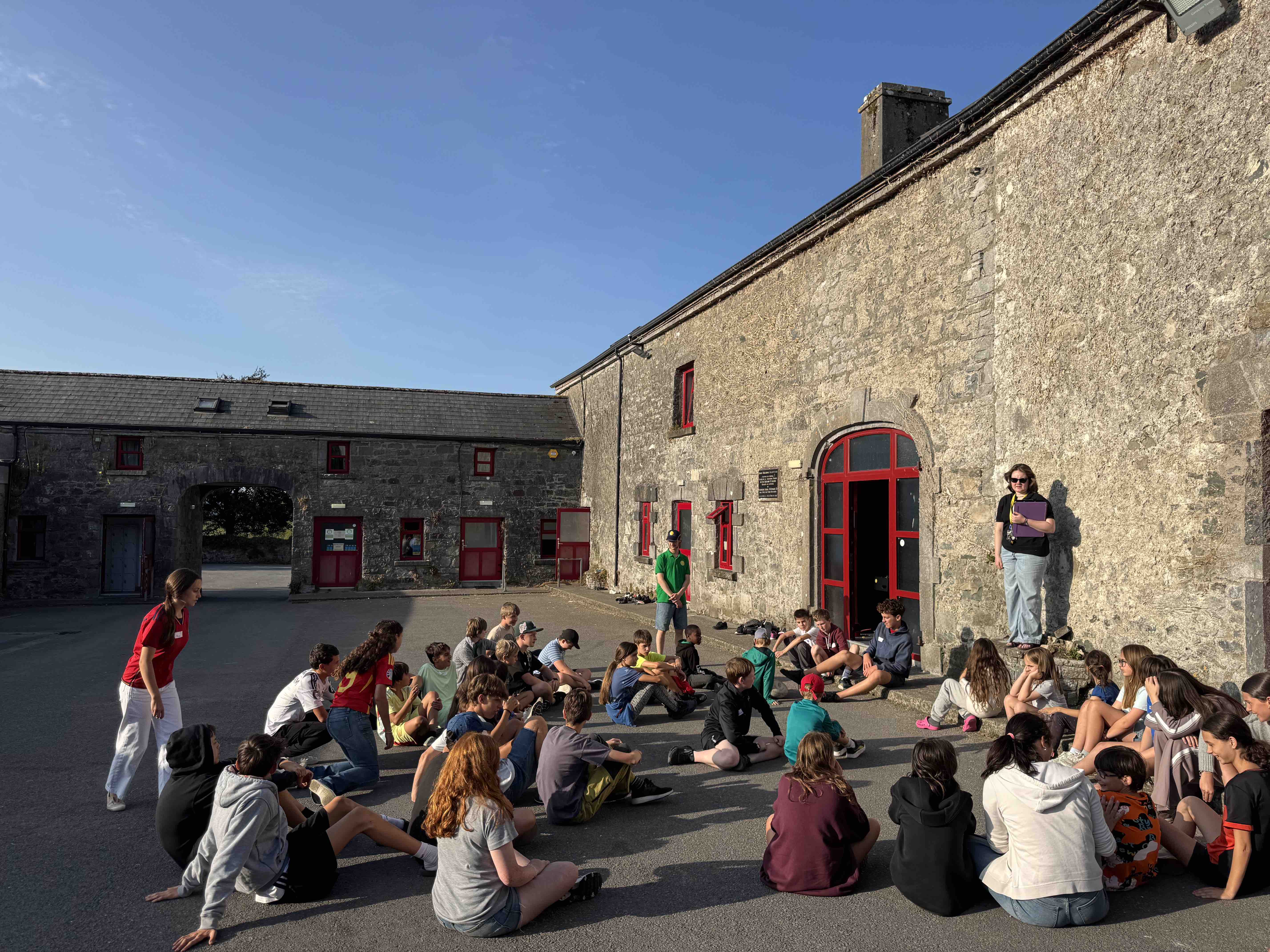 Campers gathered in the stone courtyard of the Petersburg Education Centre