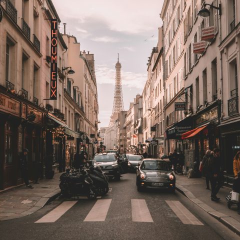 Paris street with the Eiffel Tower at the end of the avenue