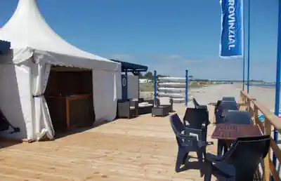 Deck and tent of the surf and sailing school on the beach at Schubystrand