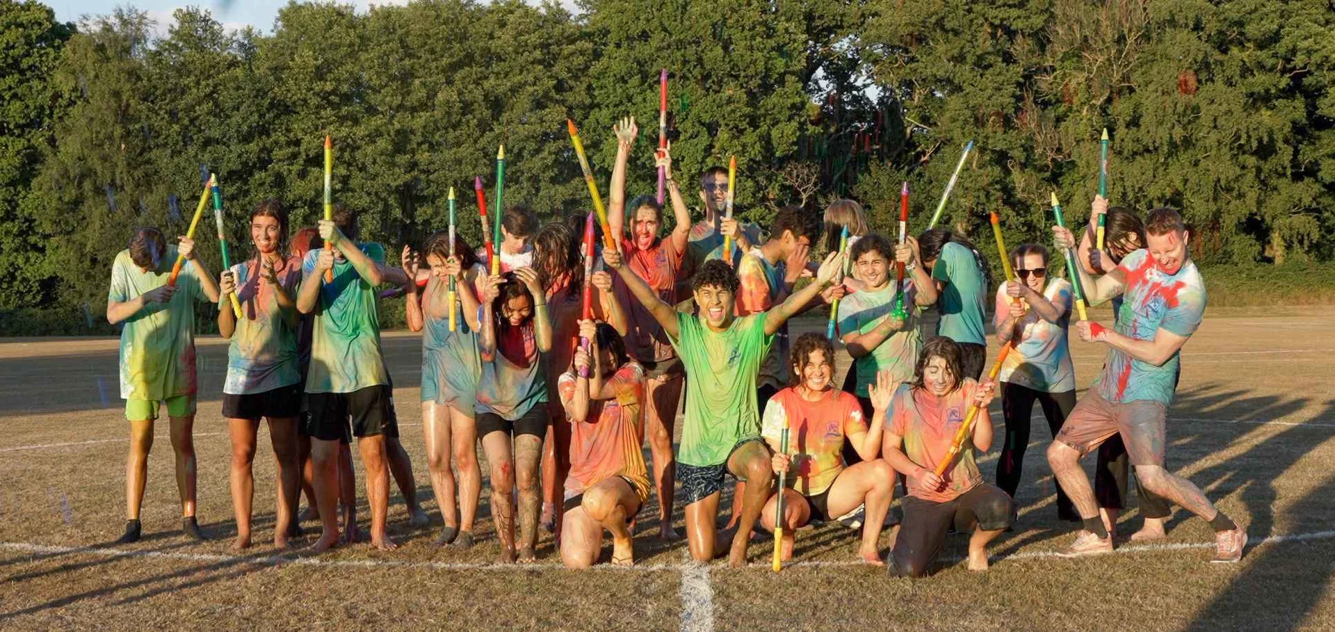 Students covered in coloured powder after the colour run on the Claremont School playing field