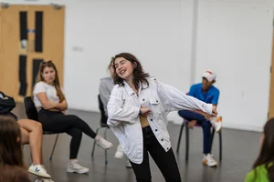 Student performing in front of classmates during a drama workshop at Claremont Summer School