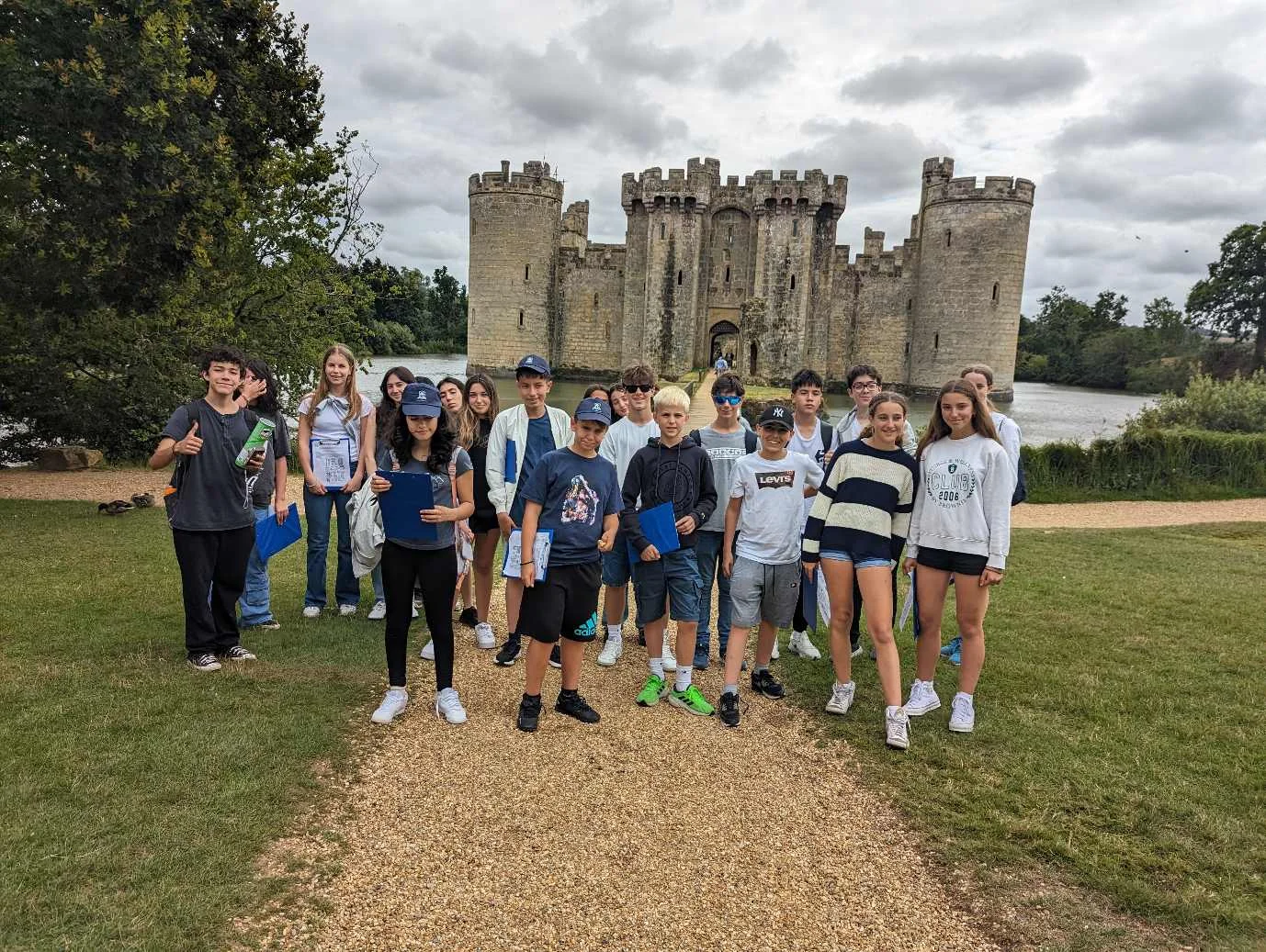 Claremont Summer School group on the path in front of Bodiam Castle