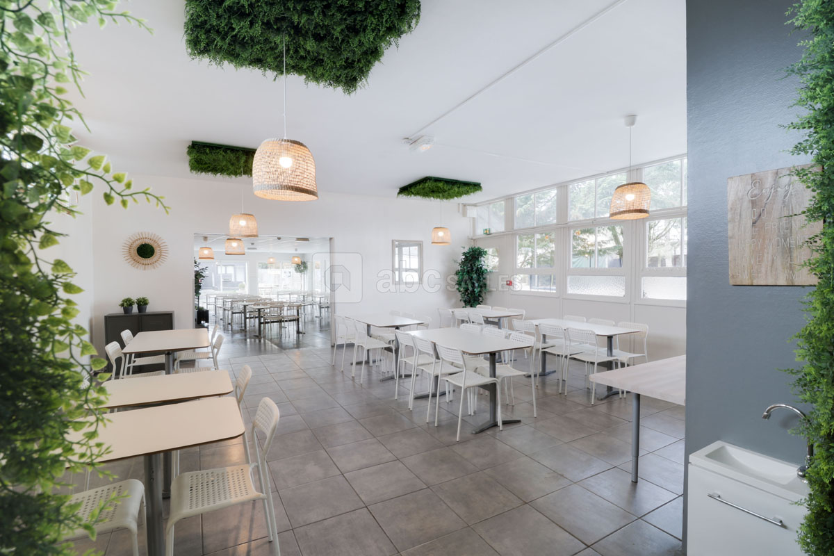 A dining room with tables and chairs set out for meals