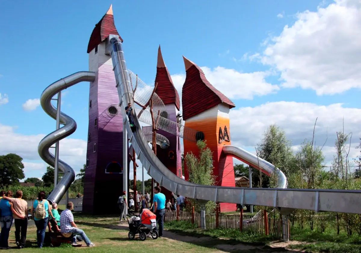 The tall metal tube slide and red-roofed play towers at the Irrlandia adventure park visited during the week