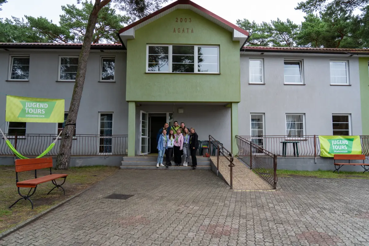 The exterior of the accommodation building at the Ferienanlage Komandor, with lawn in front