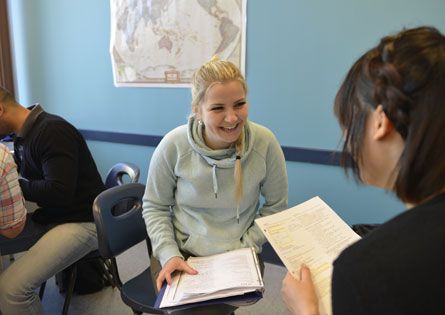 Students working in pairs at a table in a classroom at LSI Vancouver