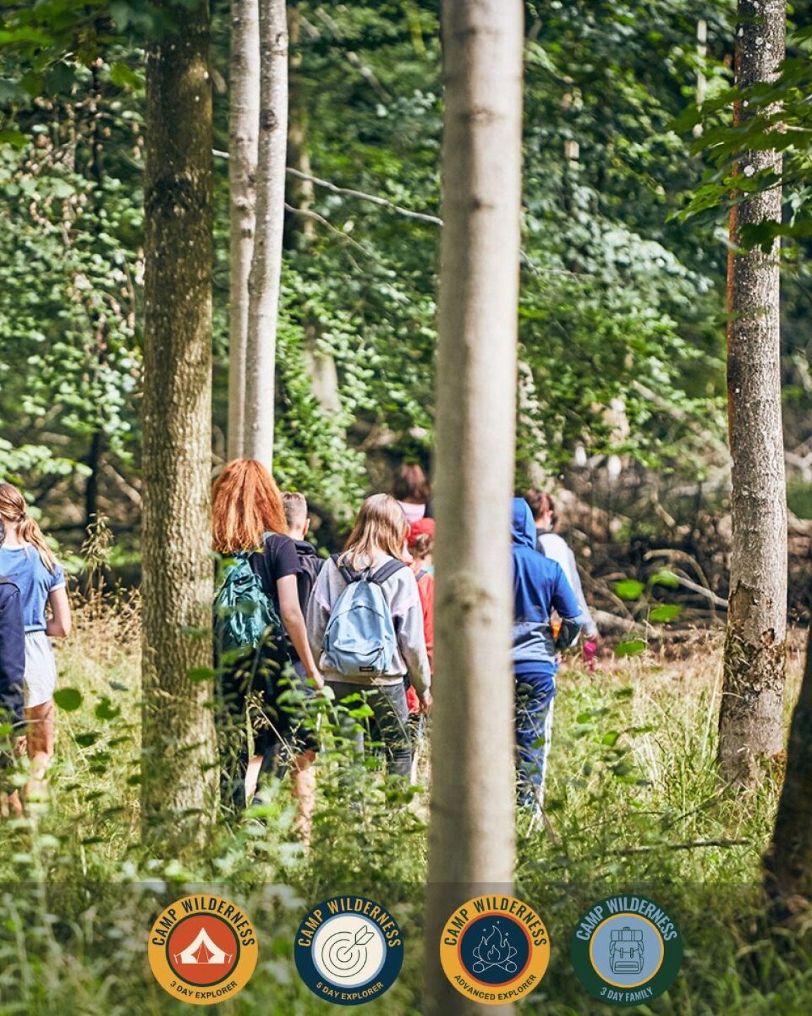 Campers walking through the woods at Penshurst Place
