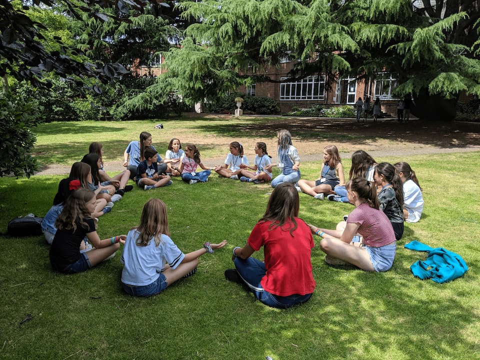 Students playing games on the lawn in the grounds at Marymount