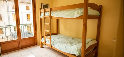 Wooden bunk beds in a bedroom at the Tour de Buis centre