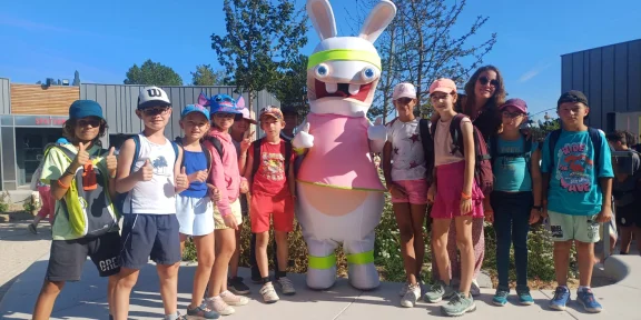 Campers beside the large cartoon-rabbit statue in the park