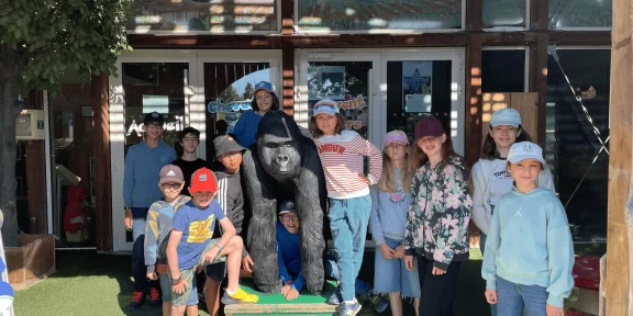 Campers gathered around the gorilla sculpture at the park entrance