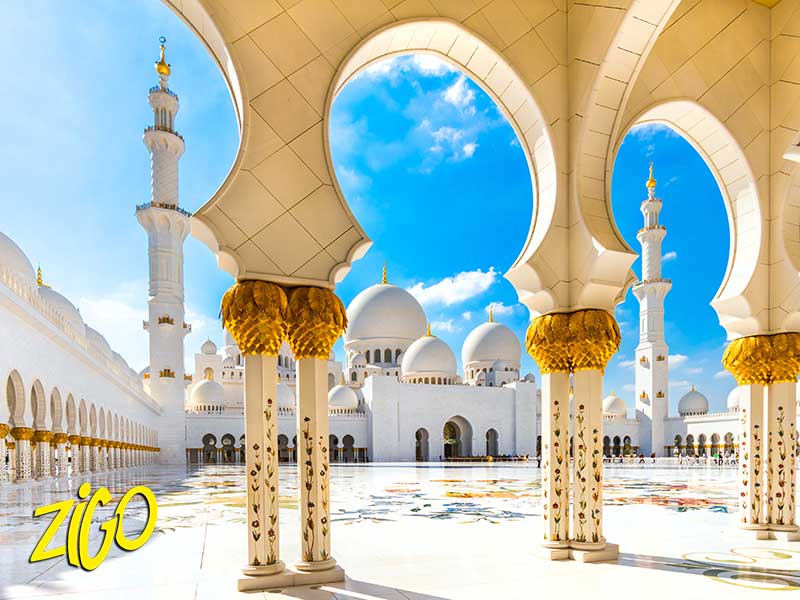 White marble arches with gilded capitals in the courtyard of the great mosque in Abu Dhabi